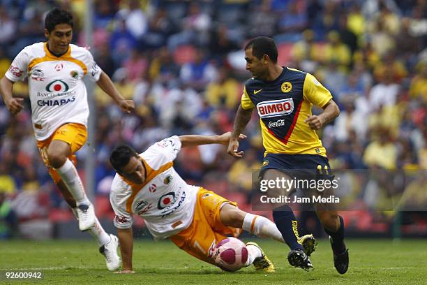 Daniel Montenegro of America vies for the ball with Oscar Razo of Jaguares during their match as part of the 2009 Opening tournament, the closing...