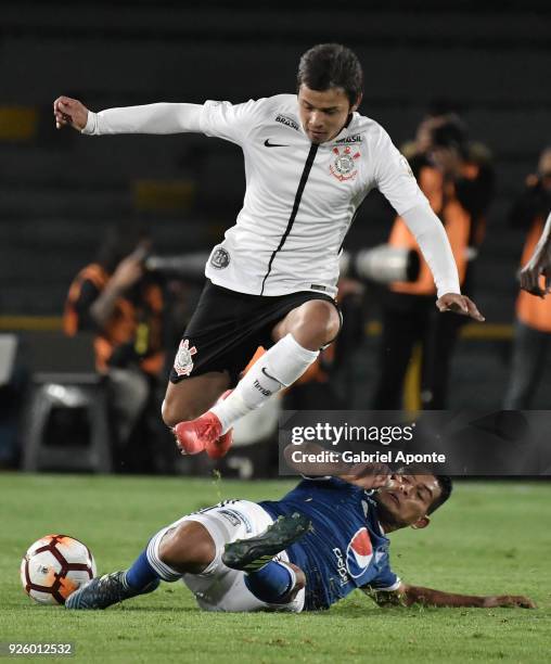 David Macalister Silva of Millonarios vies for the ball with Angel Romero of Corinthians during a Group G match between Millonarios and Corinthians...