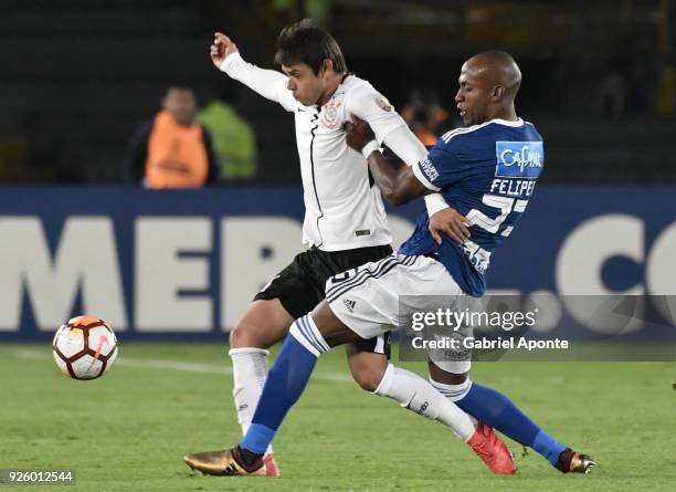 Felipe Banguero of Millonarios vies for the ball with Angel Romero of Corinthians during a Group G match between Millonarios and Corinthians as part...