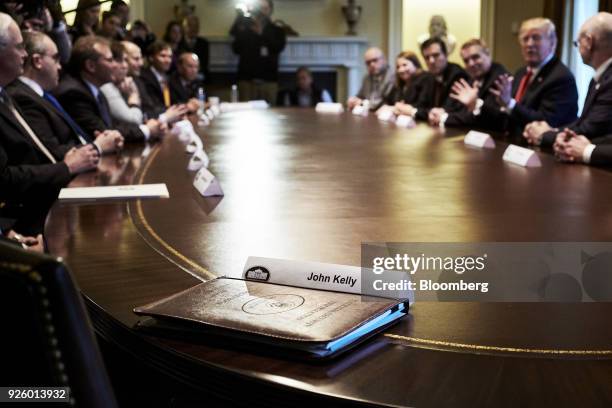 The nameplate of John Kelly, White House chief of staff, sits in front of an empty seat during a meeting with U.S. President Donald Trump and steel...