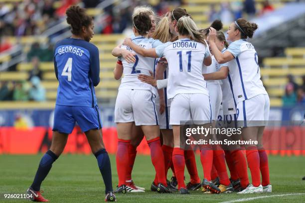 England midfielder Jill Scott celebrates with teammates after scoring a goal during the first half of the international game between England and...