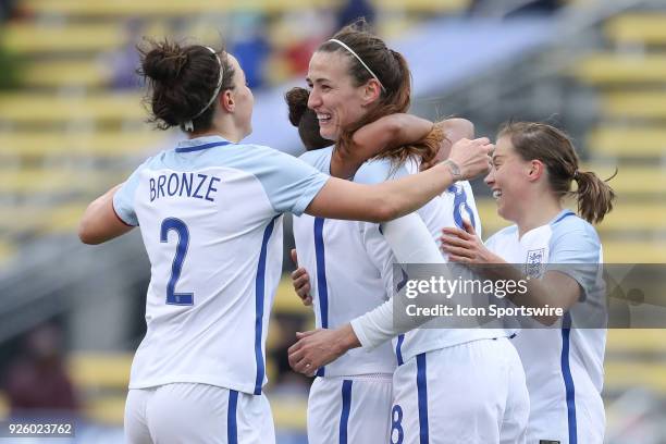 England midfielder Jill Scott celebrates with teammates after scoring a goal during the first half of the international game between England and...