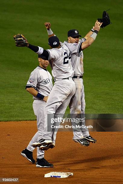 Derek Jeter, Robinson Cano and Nick Swisher of the New York Yankees celebrate their 7-4 win against the Philadelphia Phillies in Game Four of the...