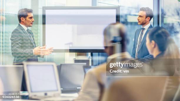 chief executive talking to financial analyst at a meeting - hedge fund stock pictures, royalty-free photos & images