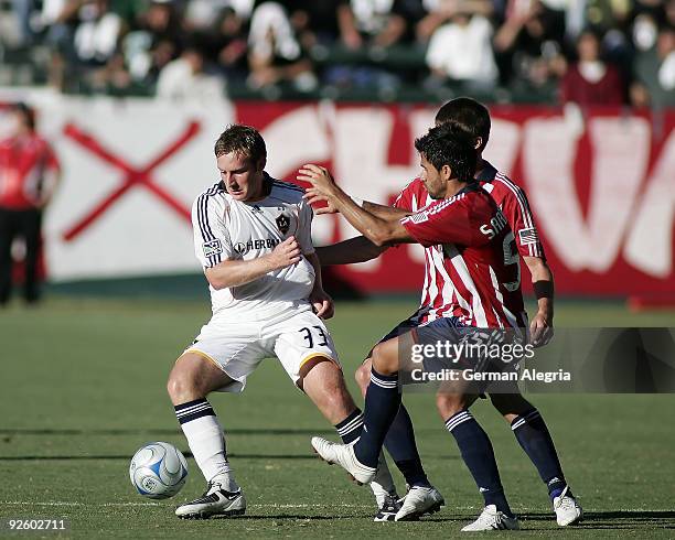 Chris Birchall of the Los Angeles Galaxy in action against Marcelo Saragosa of Chivas USA during Game One of the MLS Western Conference Semifinals at...