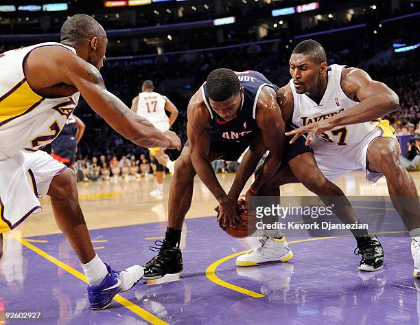 Kobe Bryant and Ron Artest of the Los Angeles Lakers pressure Joe Johnson of the Atlanta Hawks during the NBA basketball game at Staples Center on...