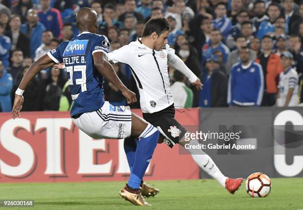 Felipe Banguero of Millonarios vies for the ball with Angel Romero of Corinthians during a Group G match between Millonarios and Corinthians as part...