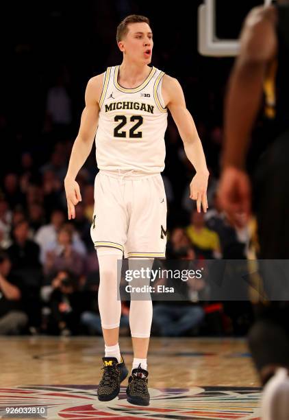 Duncan Robinson of the Michigan Wolverines celebrates his three point shot in the overtime period against the Iowa Hawkeyes during the second round...