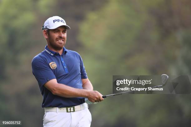 Louis Oosthuizen of South Africa watches his second shot on the 18th hole during the first round of World Golf Championships-Mexico Championship at...