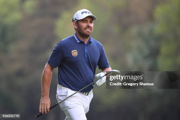 Louis Oosthuizen of South Africa watches his second shot on the 18th hole during the first round of World Golf Championships-Mexico Championship at...