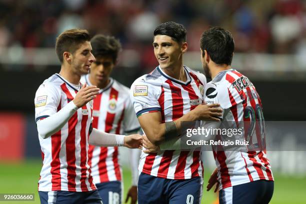 Alan Pulido of Chivas celebrates with teammates after scoring his team's fourth goal during the match between Chivas and Cibao as part of the round...