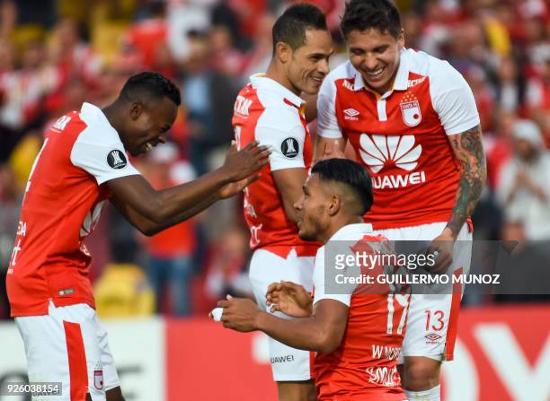 Colombian Independiente Santa Fe forward Wilson Morelo , celebrates with teammates after scoring against Ecuador's Emelec, during their Copa...