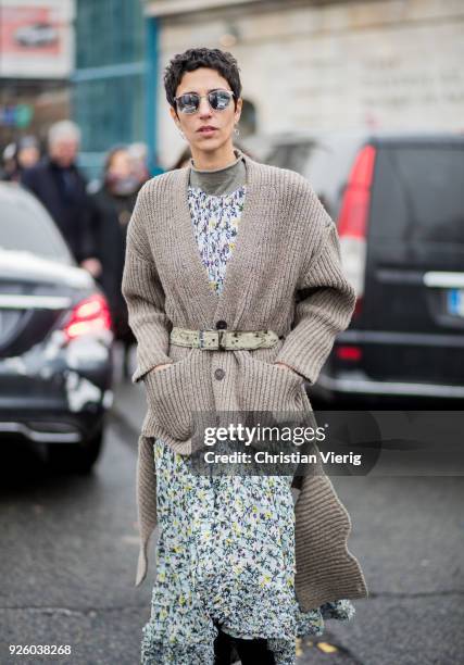 Yasmin Sewell wearing cardigan, dress with floral print is seen outside Chloe on March 1, 2018 in Paris, France.