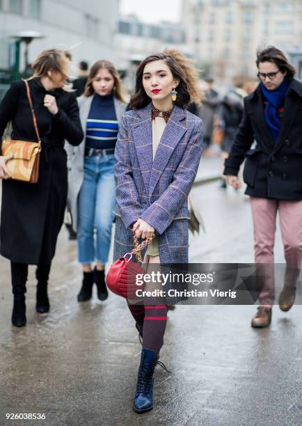 Rowan Blanchard wearing a plaid coat, Chloe bag, knee socks is seen outside Chloe on March 1, 2018 in Paris, France.