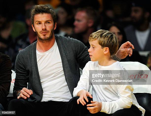 David Beckham midfielder of the Los Angeles Galaxy MLS soccer team and his son Brooklyn Beckham attend the Los Angeles Lakers and Atlanta Hawks NBA...