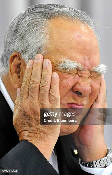 Osamu Suzuki, chairman and chief executive officer of Suzuki Motor Corp., closes his eyes during a news conference announcing the company's...