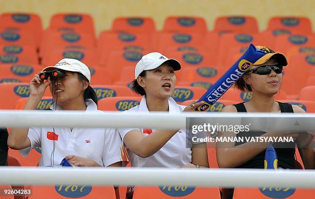 Chinese cricketers wait for the start of the fourth One-Day International between India and Australia at the Punjab Cricket Association stadium in...