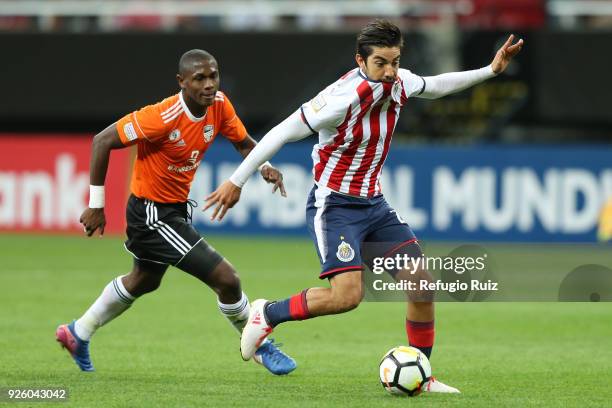 Rodolfo Pizarro of Chivas fights for the ball with Tafarel Ferreira of Cibao during the match between Chivas and Cibao as part of the round of 16th...