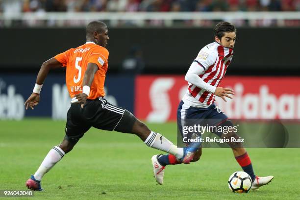 Rodolfo Pizarro of Chivas fights for the ball with Tafarel Ferreira of Cibao during the match between Chivas and Cibao as part of the round of 16th...