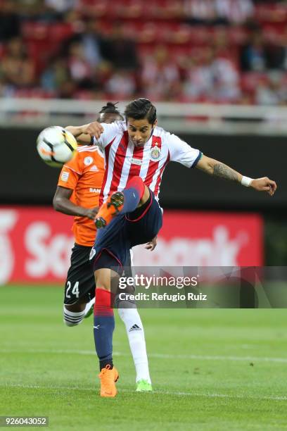 Carlos Cisneros of Chivas fights for the ball with Vaniel Sirin of Cibao during the match between Chivas and Cibao as part of the round of 16th of...