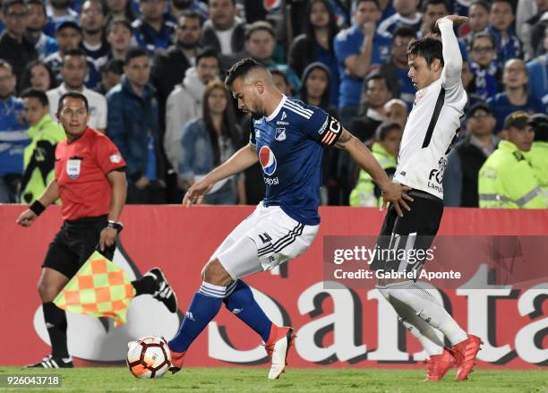 Andres Cadavid of Millonarios vies for the ball with Angel Romero of Corinthians during a Group G match between Millonarios and Corinthians as part...