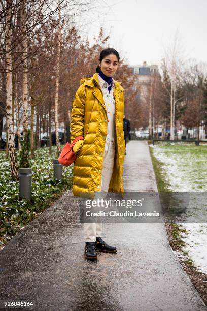 Caroline Issa, wearing a yellow wintercoat and black boots, is seen in the streets of Paris after the Chloe show during Paris Fashion Week Womenswear...