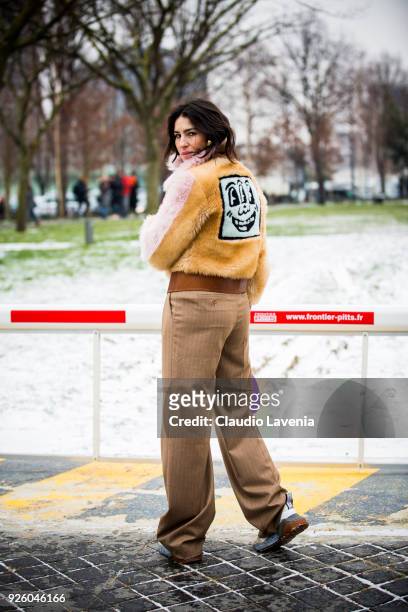 Deborah Reyner Sebag, wearing a beige fur jacket and brown pants, is seen in the streets of Paris after the Chloe show during Paris Fashion Week...