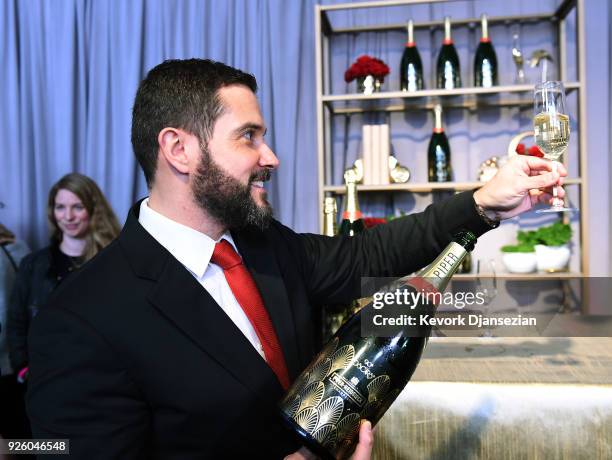 Benoit Collard, of Piper-Heidsieck, pours a glass of champagne during the 90th Annual Academy Awards Governors Ball on March 1, 2018 in Hollywood,...