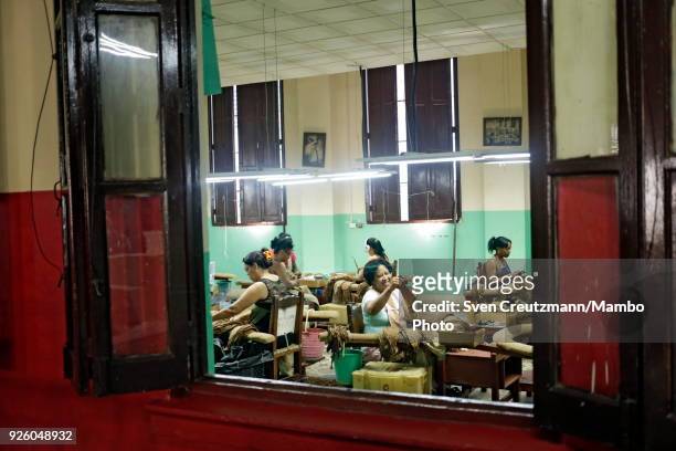 Cuban workers share a smile in the H. Upmann tobacco factory, during the annual Habanos tobacco festival, on March 1 in Havana, Cuba. The festival...