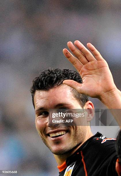 Valencia's defender David Navarro celebrates after scoring against Malaga during their Spanish league football match at La Rosaleda stadium in...