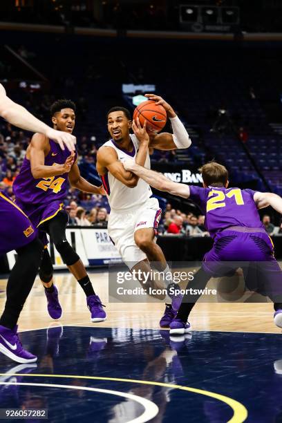 Evansville Aces guard Ryan Taylor , center, splits the defense of Northern Iowa Panthers guard Isaiah Brown , left, and Northern Iowa Panthers guard...