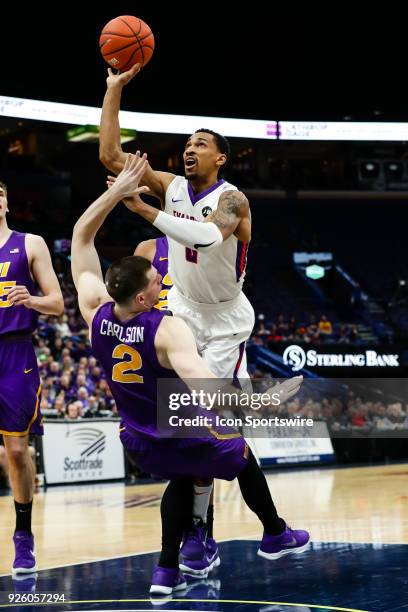 Evansville Aces guard Ryan Taylor , right, goes up for a shot over the top of Northern Iowa Panthers forward Klint Carlson during the first half of...