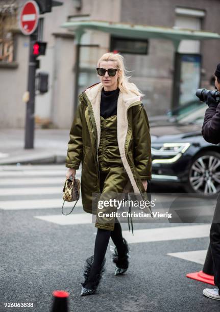 Ada Kokosar wearing olive shearling parka is seen outside Carven on March 1, 2018 in Paris, France.