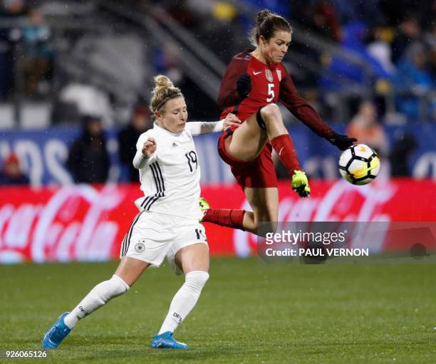 United States defender Kelley O'Hara clears the ball in front of Germany forward Svenja Huth during the first half of their SheBelieves Cup match at...