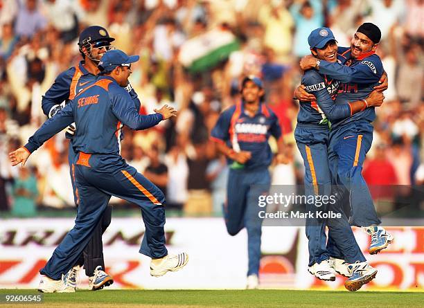 Ravindra Jadeja and Harbhajan Singh of India celebrate the run out of Ricky Ponting of Australia during the fourth One Day International match...