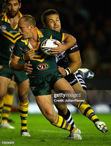 Darren Lockyer of Australia is tackled by Jarred Waerea-Hargreaves of New Zealand during the Gillette Four Nations Rugby League match between...