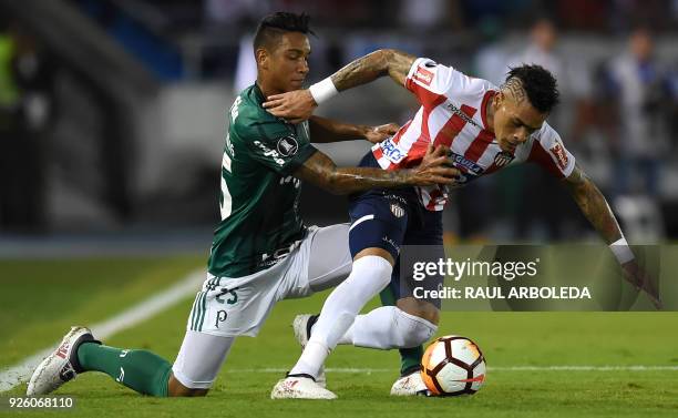 Colombias Atletico Junior player Jonatan Alvez vies for the ball with Brazil's Palmeiras player Antonio Carlos during their Copa Libertadores...