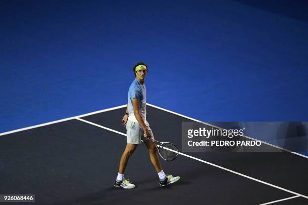 German tennis player Alexander Zverev pauses on court during his Mexico ATP 500 Open men's single tennis match against US player Ryan Harrison in...