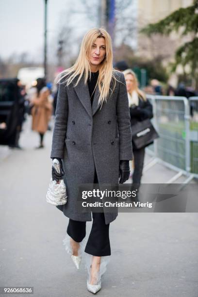 Ada Kokosar wearing bag, grey coat, heels is seen outside Rochas on February 28, 2018 in Paris, France.