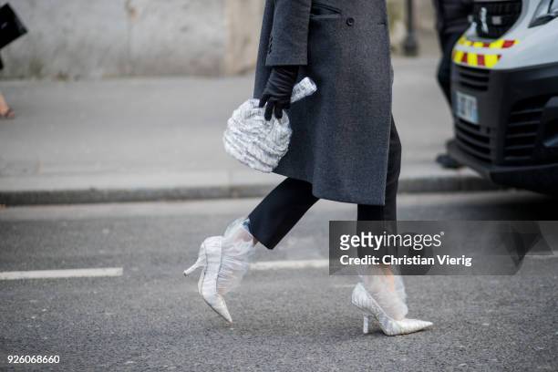 Ada Kokosar wearing bag, grey coat, heels is seen outside Rochas on February 28, 2018 in Paris, France.