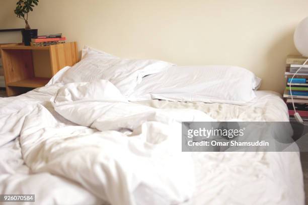 unmade bed in the morning - omar shamsuddin stock-fotos und bilder