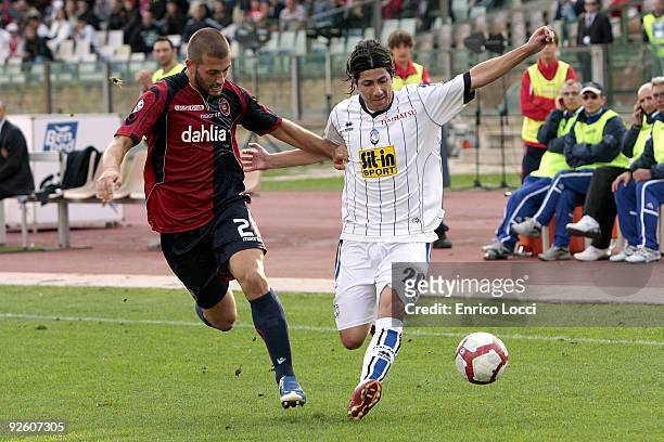 Michele Canini of Cagliari competes for the ball with valdes of Atalanta BC during the Serie A match between Cagliari and Atalanta BC at Stadio...