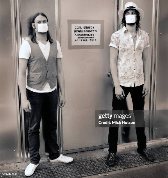 Tom Meighan and Sergio Pizzorno of Kasabian pose for a portrait wearing swine flu protection masks in Japan in May 2009.