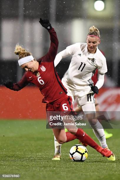 Morgan Brian of the US National Team and Alexandra Popp of Germany battle for control of the ball in the second half on March 1, 2018 at MAPFRE...
