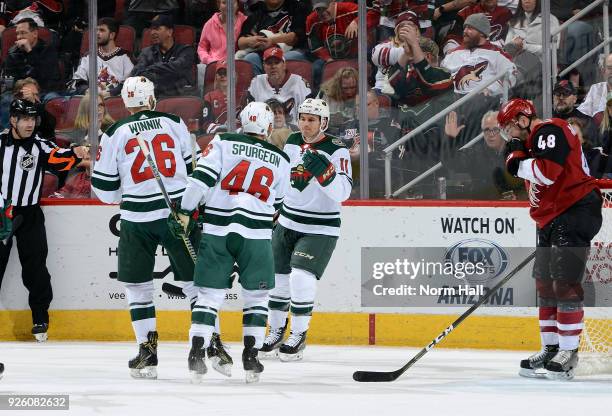 Zach Parise of the Minnesota Wild celebrates with teammates Daniel Winnik and Jared Spurgeon after his first period goal against the Arizona Coyotes...
