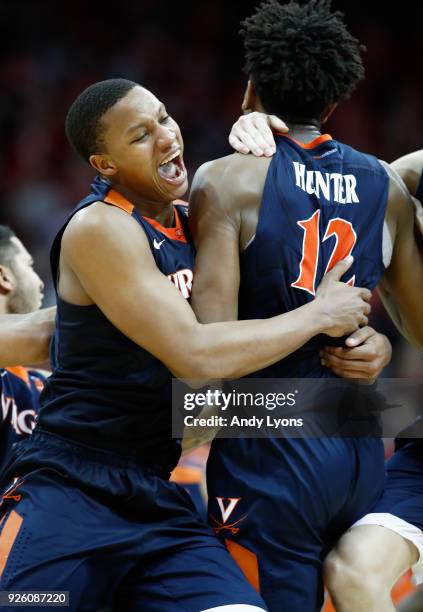 Devon Hall of the Virginia Cavaliers celebrates with De'Andre Hunter after Hunter made a 3 point shot at the buzzer to beat the Louisville Cardinals...