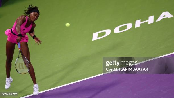 Venus Williams of the US serves to Serbia's Jelena Jankovic during their WTA Championships semi-final tennis match at the Khalifa International...