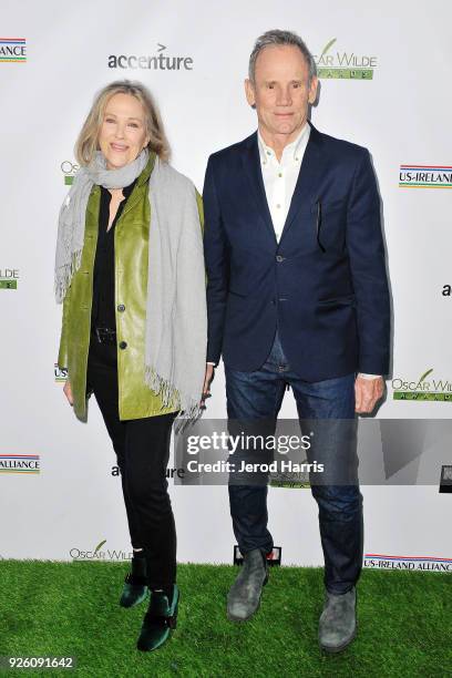 Actress Catherine O'Hara and Bo Welch arrive at the 13th Annual Oscar Wilde Awards on March 1, 2018 in Santa Monica, California.