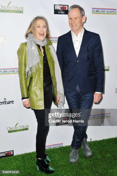 Actress Catherine O'Hara and Bo Welch arrive at the 13th Annual Oscar Wilde Awards on March 1, 2018 in Santa Monica, California.