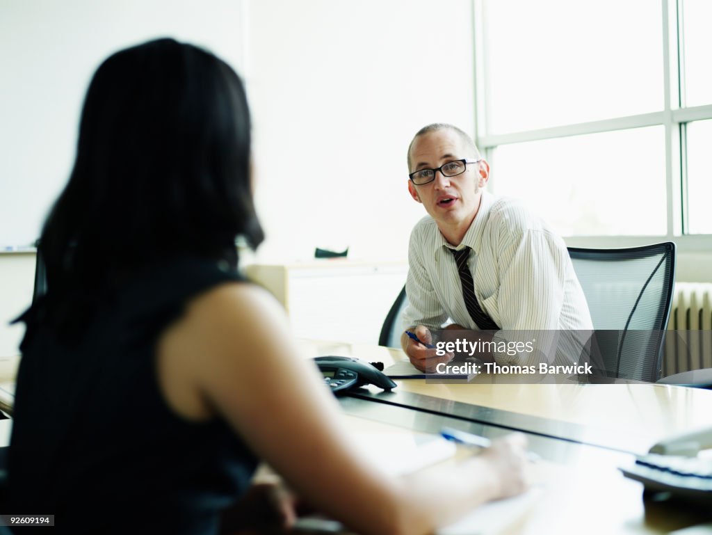 Businessman and businesswoman in discussion